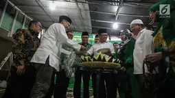 Wakil Ketua Umum (Waketum) DPP PPP Amir Uskara (tengah) memotong tumpeng selama acara Tasyakuran di Gedung DPP PPP, Diponegoro, Jakarta, Jumat (15/11). (Liputan6.com/Faizal Fanani)