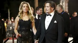 Aktor Johnny Depp menggandeng istrinya aktris Amber Heard saat menghadiri Gala Annual Palm Springs International Film Festival Awards ke-27 di California, (2/1). Johnny Depp memenangkan penghargaan Desert Palm Achievement. (REUTERS/Danny Moloshok)