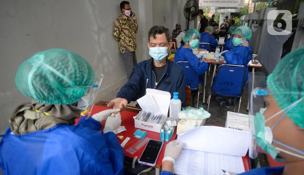 Petugas Kelompok Penyelenggara Pemungutan Suara (KPPS) menjalani rapid test Covid-19 di kantor Kelurahan Pondok Benda, Tangerang Selatan, Jumat (27/11/2020). Rapid Test tersebut diikuti 1.017 anggota KPPS serta Petugas Pengamanan Tempat Pemungutan Suara (PAM TPS). (merdeka.com/Dwi Narwoko)
