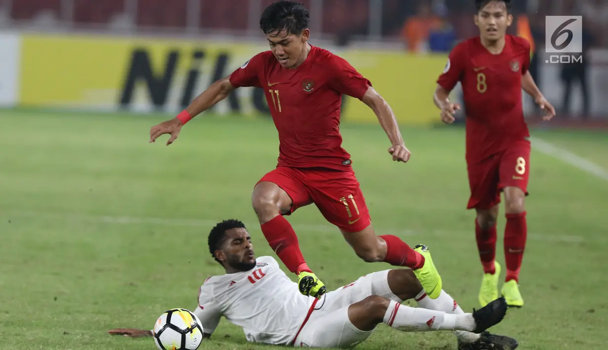 Bek timnas Indonesia -19, Firza Andika melompat menghindari tekel pemain Uni Emirat Arab U-19, Tahnoon Hamdan pada penyisihan Grup A Piala AFC U-19 2018 di Stadion GBK, Jakarta, Rabu (24/10). Indonesia unggul 1-0. (Liputan6.com/Helmi Fithriansyah)