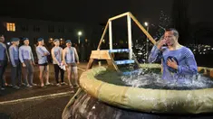 Seorang penerjun payung Rusia mengantre untuk untuk mandi dalam air dingin saat Epiphany tradisional dekat Novorossiysk, Krasnodar, Rusia, 18 Januari 2022. (AP Photo/Alexander Zemlianichenko)