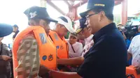 Menteri Perhubungan Budi Karya Sumadi membagikan baju pelampung ke para pengemudi kapal kecil di Dermaga Sungai Musi Pasar Tradisional 16 Palembang Sumsel (Liputan6.com / Nefri Inge)