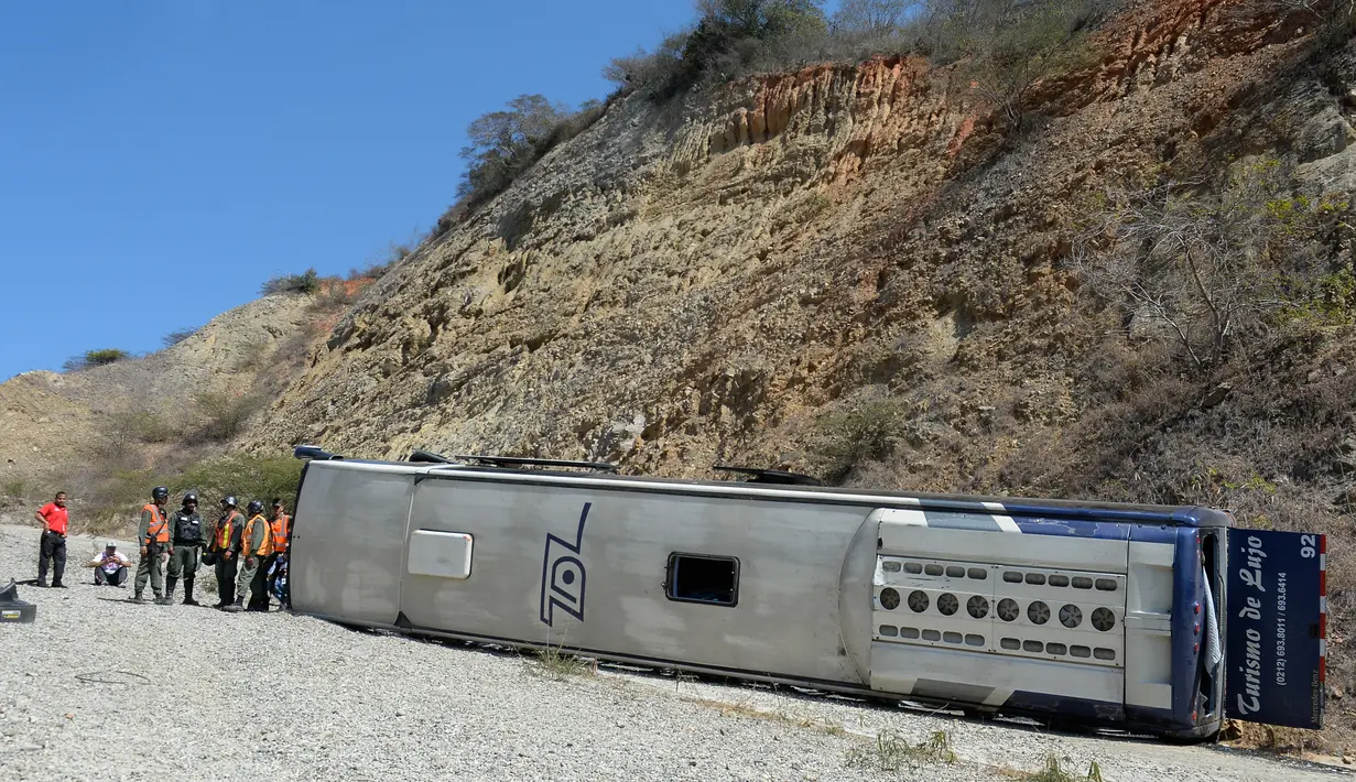 Bus berisi pemain tim sepak bola Argentina Huracan mengalami kecelakaan di jalan raya Caracas-La Guaira, Venezuela, Rabu (10/2). Pelatih dan lima pemain cedera usai bus mereka terbalik, sehari setelah pertandingan Copa Libertadores. (AFP/FEDERICO PARRA)