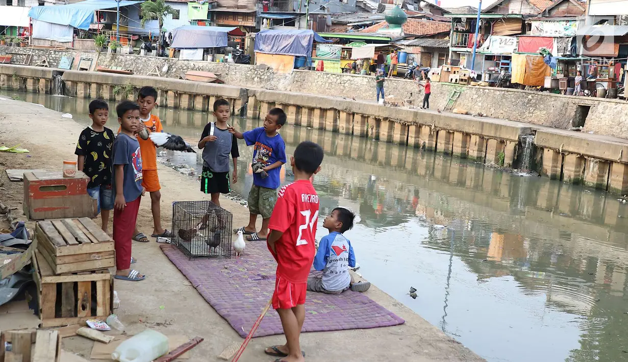 Anak-anak bermain di bantaran anak Sungai Ciliwung, Jakarta, Rabu (6/6). Meskipun tidak layak sebagai tempat bermain, namun lokasi itu menjadi tempat bagi anak-anak di kawasan tersebut untuk menunggu waktu berbuka. (Liputan6.com/Immanuel Antonius)