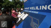 Warga mengisi formulir di Gerai Samsat Keliling di Jalan Kalibata Raya, Jakarta, Senin (11/7). Pasca libur lebaran 2016, gerai Samsat Keliling kembali beroperasi melayani pembayaran pajak kendaraan bermotor. (Liputan6.com/Helmi Fithriansyah)