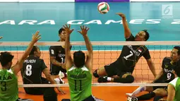 Tim voli duduk putra Indonesia melakukan smash saat berhadapan dengan Iraq pada pertandingan Asian Para Games di GBK, Jakarta, Senin (8/10). Indonesia kalah tiga set langsung dari Iraq. (Merdeka.com/Imam Buhori)