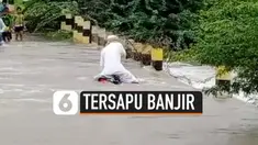 Seorang pengendara motor terbawa arus banjir di Vijayapura, India. Ia berhasil menyelamatkan diri setelah berenang ke tempat yang aman.
