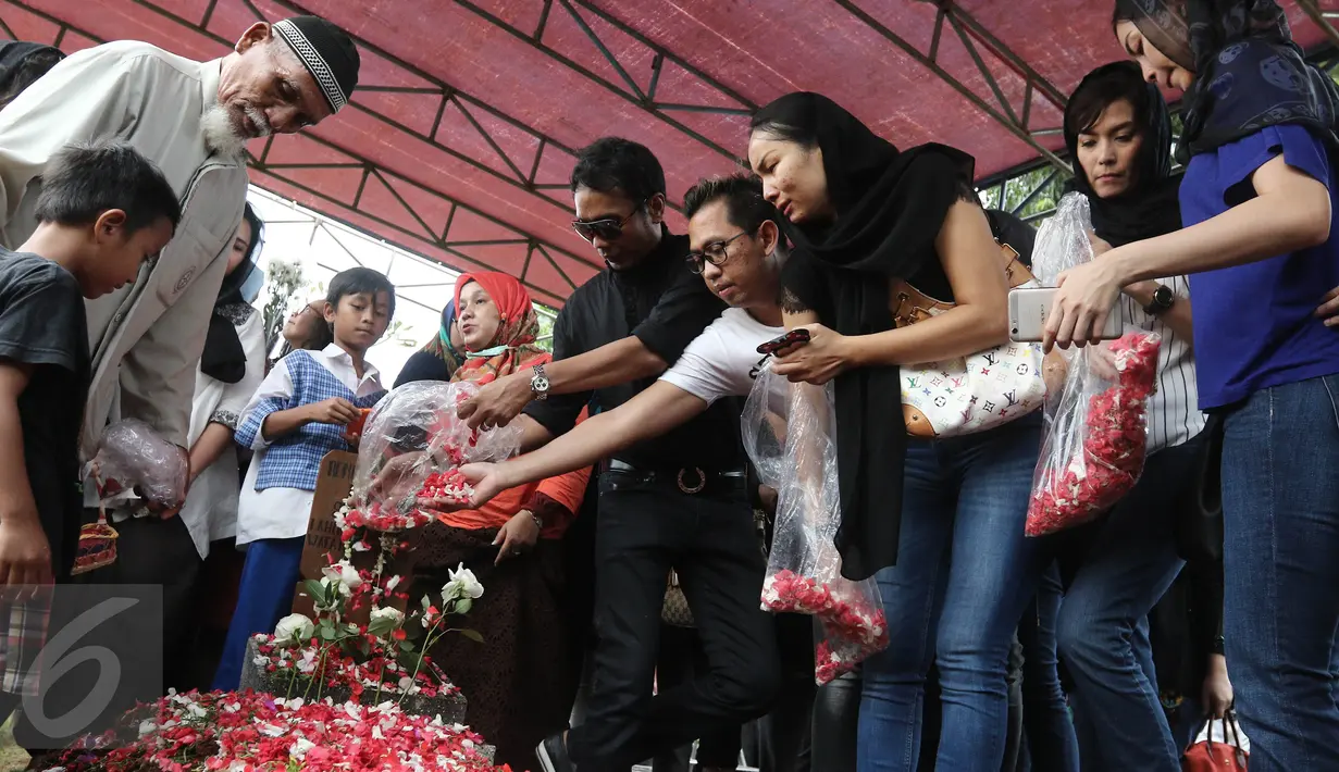 Penaburan bunga di makam Renita Sukardi di TPU Menteng Pulo, Jakarta, Senin (10/4). Renita Sukardi menghembuskan napas terakhirnya di usia 37 tahun. Ia meninggalkan seorang suami dan anak laki-laki. (Liputan6.com/Herman Zakharia)