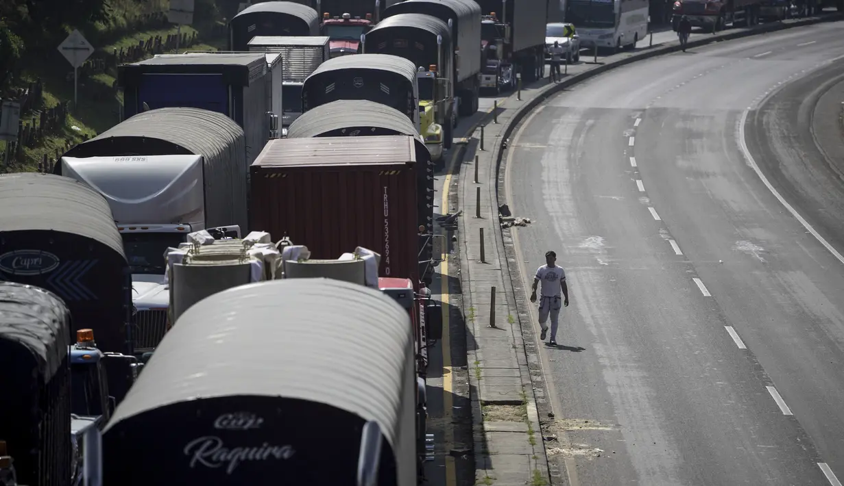 Pengemudi truk memblokir jalan raya saat protes terhadap kenaikan harga solar di Cajica, utara Bogota, Kolombia, Rabu (4/9/2024). (AP Photo/Ivan Valencia)