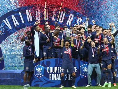 Bek Paris Saint-Germain #05 Marquinhos (tengah) mengangkat trofi Coupe de France 2023/2024 saat berselebrasi dengan timnya setelah menang atas Olympique Lyon pada laga final di Stadion Pierre-Mauroy, Minggu (26/5/2024) dini hari WIB. (FRANCK FIFE / AFP)