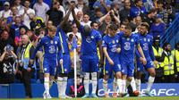 Chelsea's Romelu Lukaku (covered by his teammates) celebrates after scoring a goal against Wolverhampton Wanderers during the English Premier League soccer match at Stamford Bridge Stadium, London, England, 7 May 2022. The match ends 2-2.  (AP Photo/Frank Augstein)