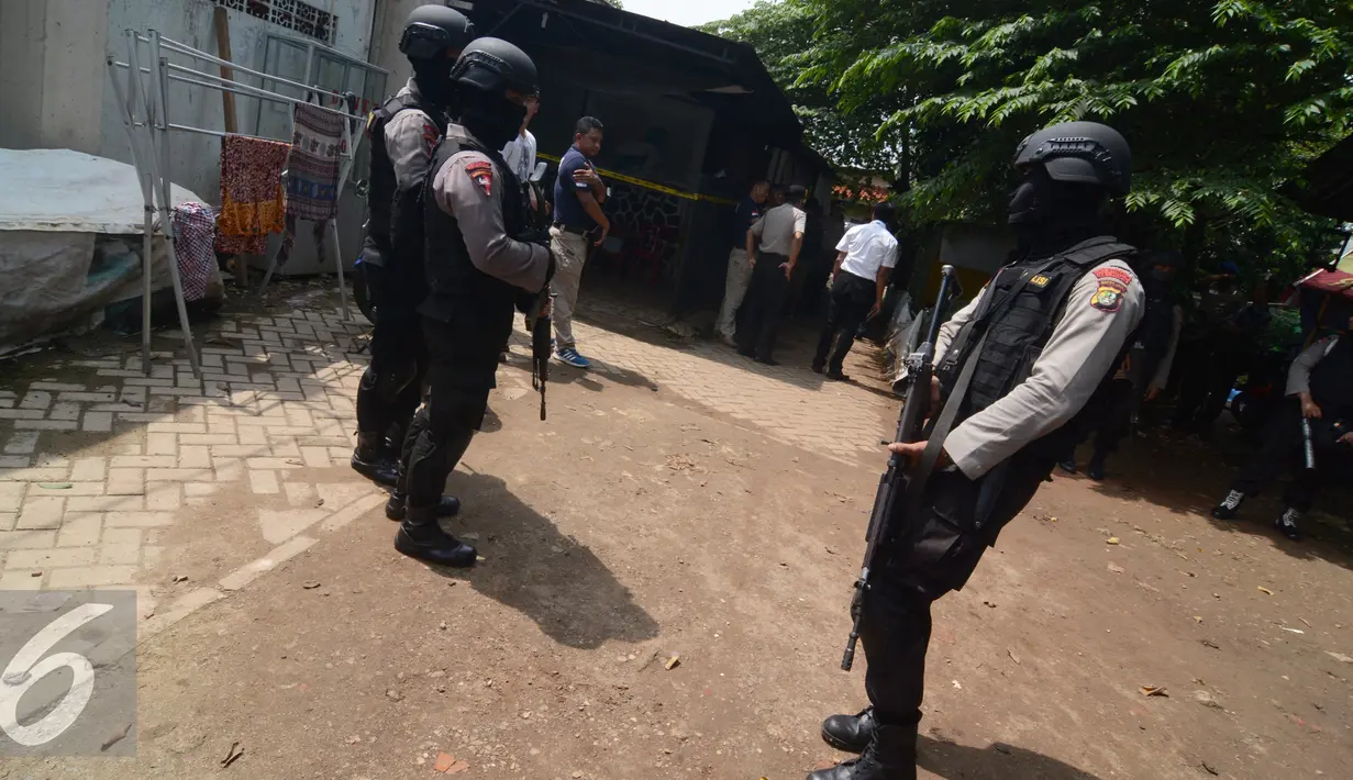 Petugas kepolisian dari Densus 88 berjaga yang diduga markas teroris di Tangerang Selatan, Banten, Kamis (28/1/2016). Penggeledahan ini merupakan pengembangan dari penangkapan terduga teroris berinisial K dan M. (Liputan6.com/Faisal R Syam)