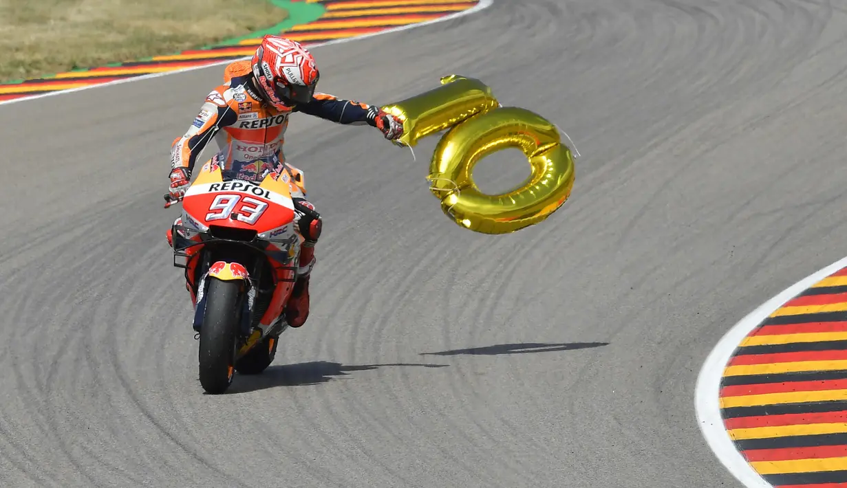 Marc Marquez membawa balon angka 10 merayakan kemenangannya di Sirkuit Sachsenring GP Jerman. (AFP/Tobias Schwarz)