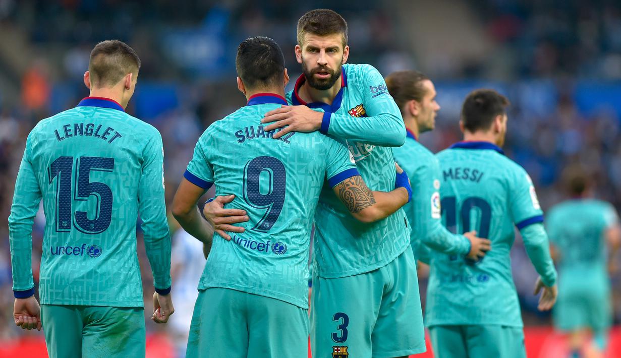 Para pemain Barcelona merayakan gol yang dicetak Luis Suarez ke gawang Real Sociedad pada laga La Liga di Stadion Anoeta, San Sebastian, Sabtu (14/12). Kedua klub bermain imbang 2-2. (AFP/Ander Gillenea)