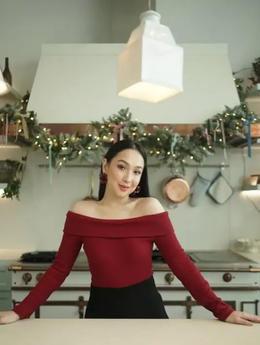 Agatha Pricilla tampil mengenakan off shoulder merah lengan panjang dipadukan bawah hitam. Ia melengkapi tampilannya dengan anting-anting bunga mawar besar. [@agthpricilla]