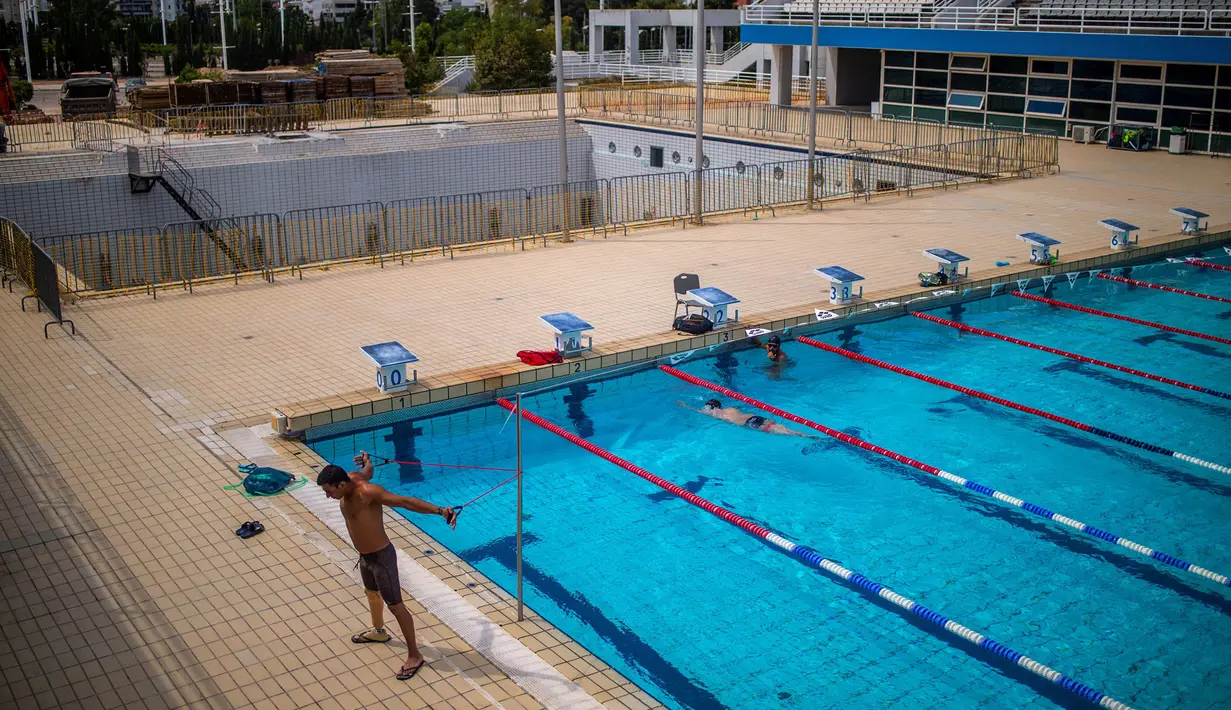 Saat ini, Ia tergabung dalam tim pengungsi yang terdiri dari delapan anggota dan melakukan latihan setiap harinya untuk persiapan Paralimpiade Tokyo 2020. (Foto: AFP/Angelos Tzortzinis)