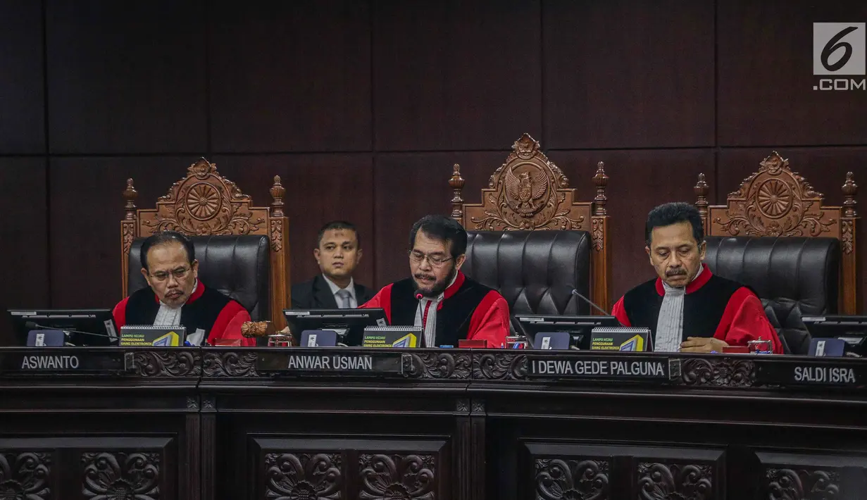 Ketua Majelis Hakim Konstitusi Anwar Usman (tengah) saat membacakan putusan MK di Gedung MK, Jakarta, Kamis (27/6/2019). MK menolak seluruh gugatan hasil Pilpres 2019 yang diajukan Prabowo Subianto-Sandiaga Uno yang disepakati sembilan hakim konstitusi. (Liputan6.com/Faizal Fanani)