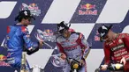 Enea Bastianini (tengah), Alex Rins (kiri), dan Jack Miller merayakan kemenangan mereka pada balapan MotoGP Amerika Serikat di Circuit of the Americas, Austin, Texas, Amerika Serikat, 10 April 2022. Enea Bastianini juara satu, Alex Rins juara dua, dan Jack Miller juara tiga. (AP Photo/Eric Gay)