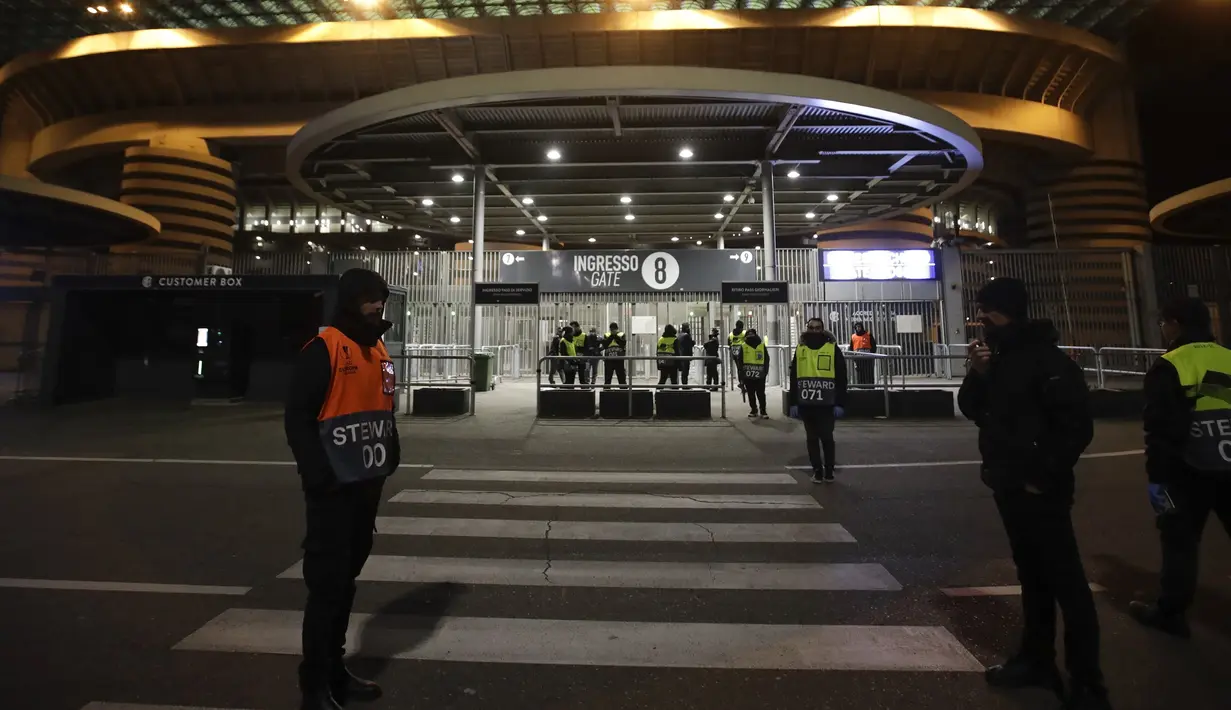 Pengurus berjaga di luar Stadion San Siro di Milan, Italia (27/2/2020). Akibat virus COVID-19 yang sedang mewabah, pertandingan leg kedua babak 32 besar Liga Europa UEFA antara Inter Milan melawan Ludogorets dimainkan tanpa penonton. (AP Photo/Luca Bruno)
