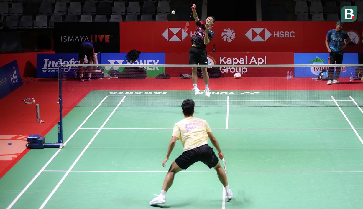 Pebulu tangkis tunggal putra Indonesia, Jonatan Christie (atas) dan Anthony Sinisuka Ginting melakukan latihan menjelang Indonesia Open 2023 di Istora Senayan, Jakarta, Senin (12/06/2023). Turnamen BWF Super 1000 tersebut diikuti oleh 268 atlet dari 20 negara yang berlangsung pada 13-18 Juni 2023. (Bola.com/Bagaskara Lazuardi)