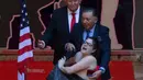 Petugas menangkap aktivis femen yang bertelanjang dada saat saat acara pembukaan patung lilin Presiden AS terpilih Donald Trump di Madrid's wax museum di Madrid, Spanyol, Selasa (17/1). (AP Photo/Paul White)