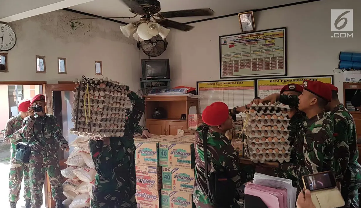 Prajurit Kopassus membawa sembako untuk warga terdampak gempa di Desa Citalahap, Kabupaten Lebak, Bogor (23/1). Gempa berkekuatan 6,1 Skala Richter, tersebut mengguncang sebagian wilayah di pulau Jawa bagian barat. (LIputan6.com/Pool/Kopassus)