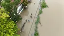 Tim penyelamat di Filipina utara melakukan evakuasi dengan menjemput warga yang terdampar akibat banjir dan mengirimkan pasokan dengan perahu. (Ted ALJIBE/AFP)