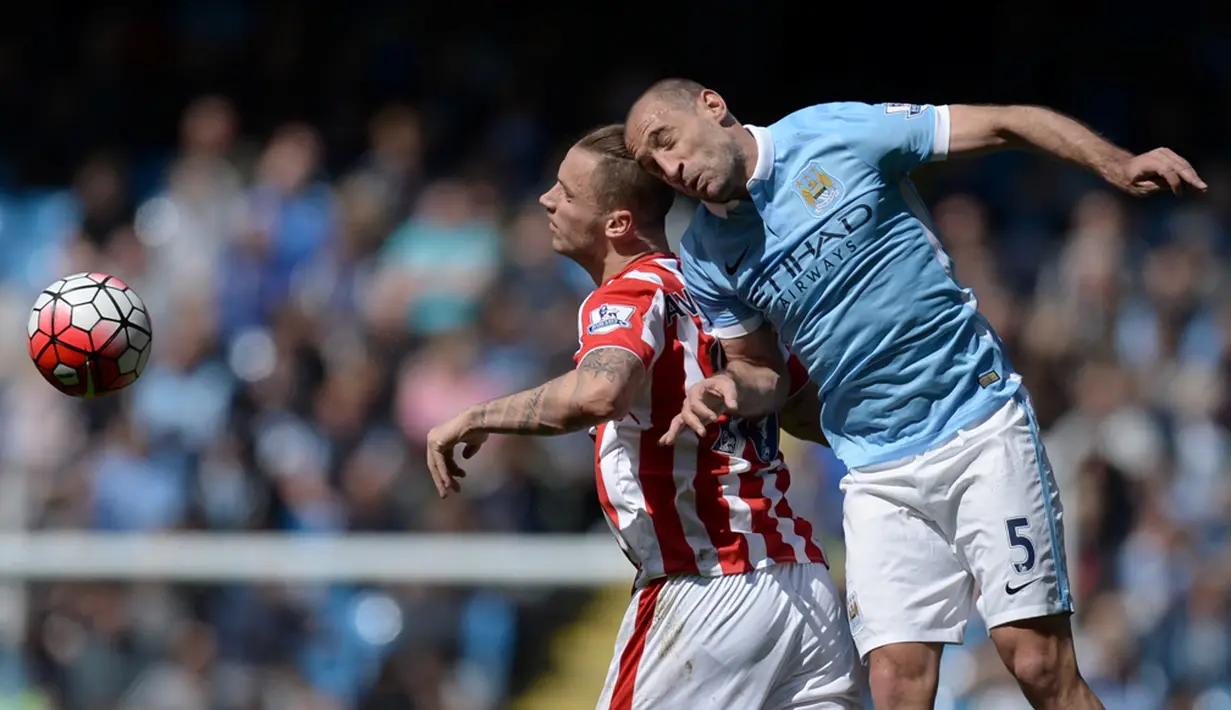 Pemain Manchester City, Pablo Zabaleta, berebut bola dengan pemain Stoke City, Marko Arnautovic, dalam laga Liga Inggris di Stadion Etihad, Manchester, Sabtu (23/4/2016). (AFP/Oli Scarff)