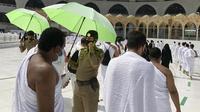 Polisi mengawasi umat muslim untuk memastikan jaga jarak sosial untuk membantu menghentikan penyebaran virus corona COVID-19 saat pelaksanaan umrah di Masjidil Haram, Makkah, Arab Saudi, Minggu (30/5/2021). (AP Photo/Amr Nabil)