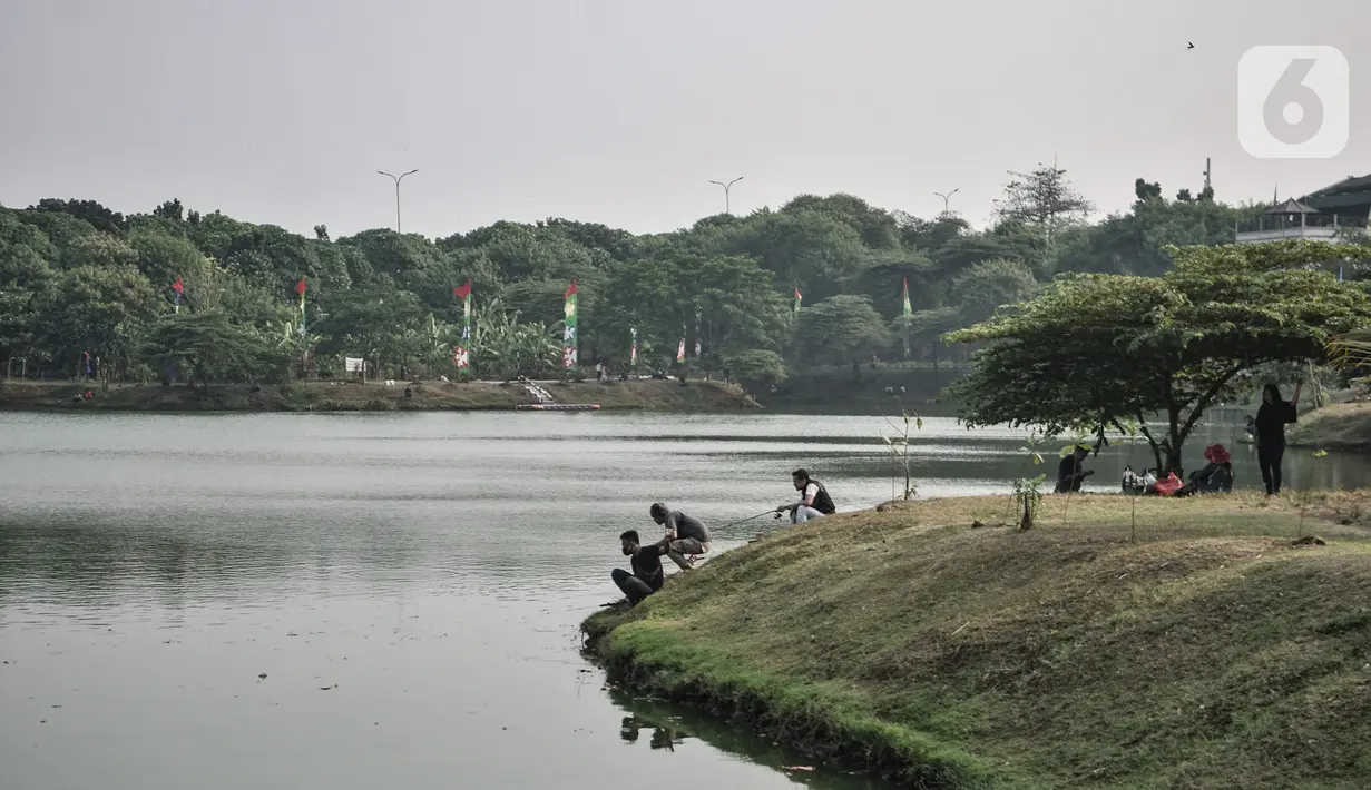 Warga memancing di Waduk Setu, Cipayung, Jakarta, Selasa (28/7/2020). Saat ini Waduk Setu tengah dibuat jalur olahraga dan juga akan dilengkapi sarana bermain anak, pentas seni budaya serta pusat kuliner yang diharapkan meningkatkan potensi kawasan ekonomi pariwisata. (merdeka.com/Iqbal S. Nugroho)