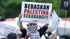 Massa membentangkan tulisan saat berunjuk rasa di depan Kedubes AS Jalan Medan Merdeka Selatan, Jakarta, Selasa (3/4). Aksi ini dukungan moral kepada rakyat Palestina yang ingin pulang ke tanah kelahiran. (Liputan6.com/Helmi Fithriansyah)