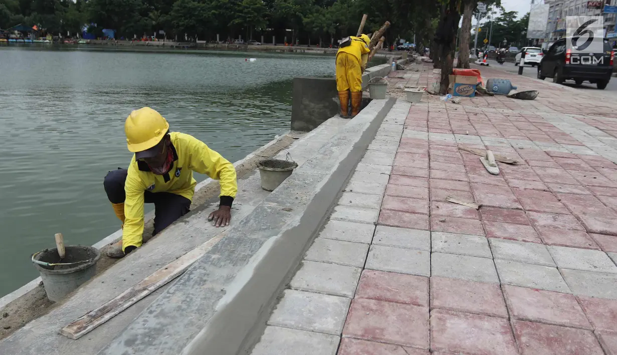 Petugas membuat tangga di pinggir Danau Sunter, Jakarta Utara, Senin (19/2). Menurut rencana, Festival Danau Sunter akan dimeriahkan sejumlah atraksi dari berbagai komunitas olahraga air seperti ski, renang, dan dayung. (Liputan6.com/Arya Manggala)