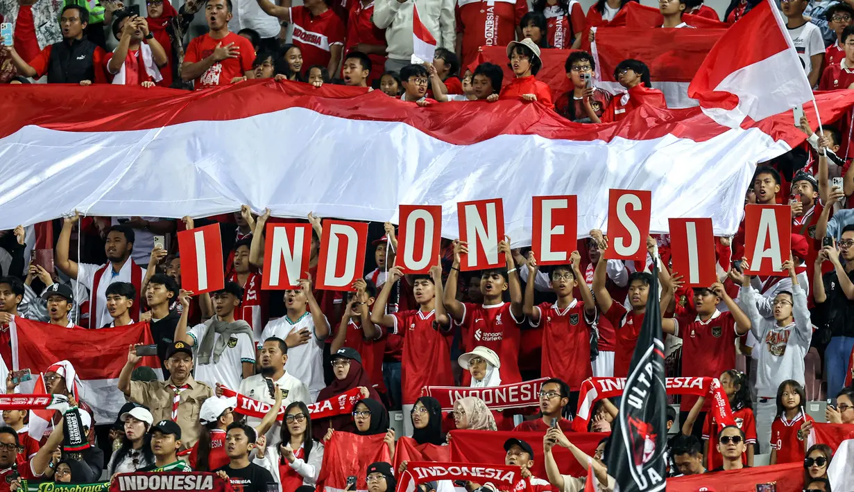 Para suporter Indonesia memberi dukungan saat Timnas Indonesia U-23 menghadapi Yordania U-23 pada laga ketiga Grup A Piala Asia U-23 2024 di Abdullah bin Khalifa Stadium, Doha, Qatar, Minggu (21/4/2024). (AFP/Karim Jaafar)