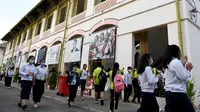 Sejumlah pelajar mengenakan masker saat beraktivitas di sebuah sekolah di Phnom Penh (28/1/2020). Pemerintah Kamboja dalam beberapa hari terakhir telah menutup aktivitas belajar di sekolah-sekolah sebagai upaya pencegahan terhadap virus corona. (TANG CHHIN SOTHY/AFP)
