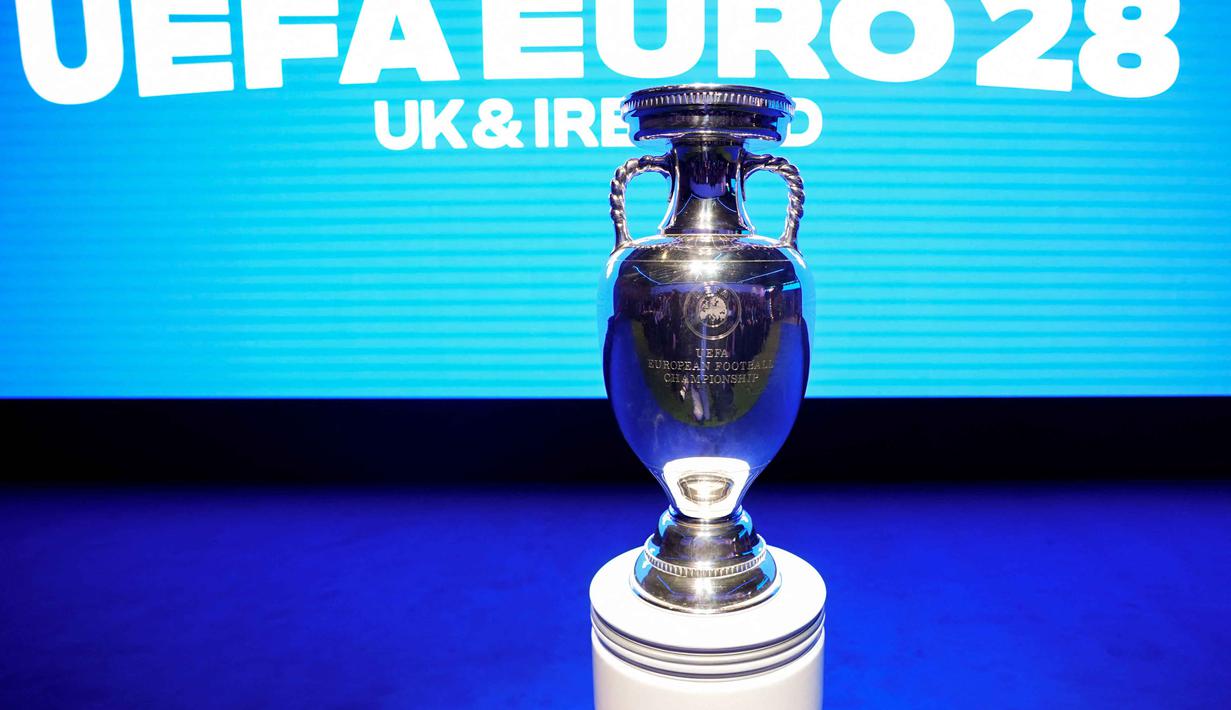 Kompetisi akan berlangsung di sembilan stadion yang tersebar di Inggris, Skotlandia, Wales, dan Republik Irlandia, menjadikannya sebagai salah satu ajang terbesar yang pernah diselenggarakan di kawasan Britania Raya. Tampak dalam foto, trofi EURO atau Piala Henri Delaunay ditampilkan sebelum acara peluncuran turnamen sepak bola UEFA EURO 2028 di Below The Lights, London Pusat, pada 12 November 2025. (James Manning/POOL/AFP)