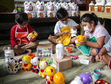 Anak-anak mewarnai boneka karakter kartun di Saung Art Gallery, Pondok Cabe, Tangerang Selatan, Banten, Kamis (6/1/2022). Selain menjadi sarana edukasi, boneka berbahan gipsum yang dapat digunakan sebagai celengan ini dijual dengan harga Rp 20 ribu-Rp 40 ribu per buah. (Liputan6.com/Faizal Fanani)
