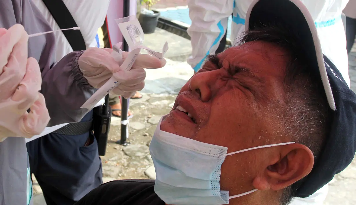 Seorang warga saat mengikuti pemeriksaan tes swab antigen di Polsek Pamulang, Tangerang Selatan pada Rabu (19/5/2021). Swab antigen gratis itu bagi warga Pamulang yang sudah kembali usai menjalani perjalanan mudik untuk antisipasi penularan virus corona COVID-19. (merdeka.com/Arie Basuki)