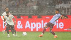 Hujan deras yang turun saat laga uji coba antara Manchester United melawan Aston Villa di Optus Stadium, Perth, Sabtu (23/7/2022) membuat pergerakan sejumlah pemain agak terhambat. (AFP/Trevor Collens)