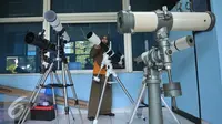 Petugas menyiapkan sejumlah teleskop untuk digunakan saat pengamatan gerhana matahari di Planetarium dan Observatorium, Taman Ismail Marzuki, Jakarta, Selasa (8/3). (Liputan6.com/Gempur M Surya)
