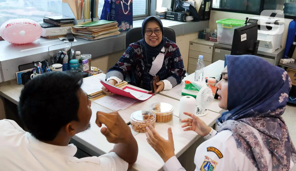 Aparatur Sipil Negara (ASN) Pemerintah Provinsi (Pemprov) DKI Jakarta menyelesaikan pekerjaannya di Balai Kota DKI Jakarta, Rabu (26/4/2023). ASN Pemprov DKI Jakarta dijadwalkan masuk pukul 07.30 setelah cuti bersama pada 19-25 April 2023 dan jam kerja pegawai ASN sebanyak 37 jam 30 menit dalam satu minggu tidak termasuk jam istirahat. (Liputan6.com/Herman Zakharia)