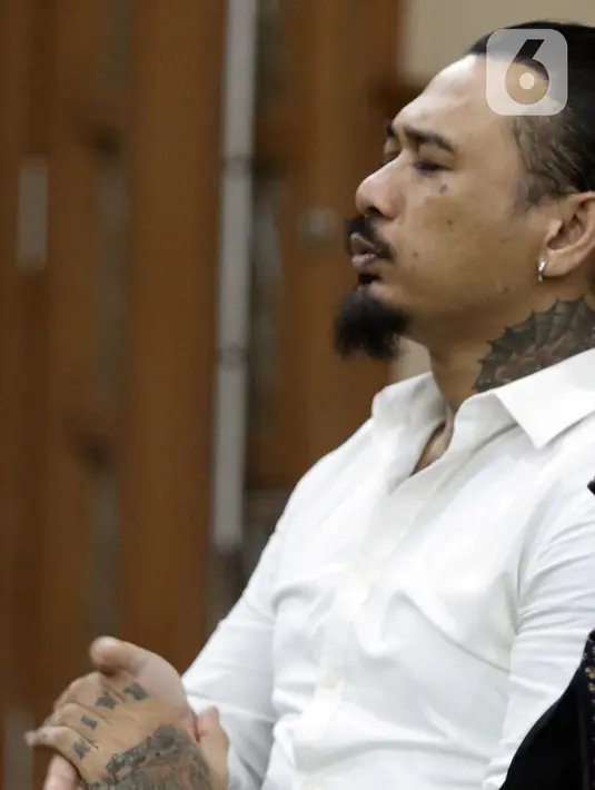 Musisi I Gede Ari Astina alias Jerinx SID sesaat sebelum sidang pembacaan putusan kasus dugaan pengancaman terhadap Adam Deni di PN Jakarta Pusat, Kamis (24/2/2022). I Gede Ari Astina divonis satu tahun penjara, denda Rp 25 juta subsider satu bulan kurungan. (Liputan6.com/Helmi Fithriansyah)