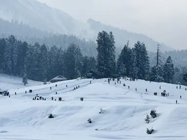 Suasana saat para wisatawan mengunjungi resor ski di Gulmarg, sekitar 55 km utara Srinagar, Jammu dan Kashmir, India, 25 Januari 2021. Gulmarg merupakan destinasi wisata salju di Jammu dan Kashmir. (Tauseef MUSTAFA/AFP)