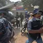 Sejumlah petugas menenangan warga saat kepanikan terjadi akibat gempa susulan melanda di Tanjung pulau Lombok, NTB, Kamis (9/8).(AFP/ ADEK BERRY)