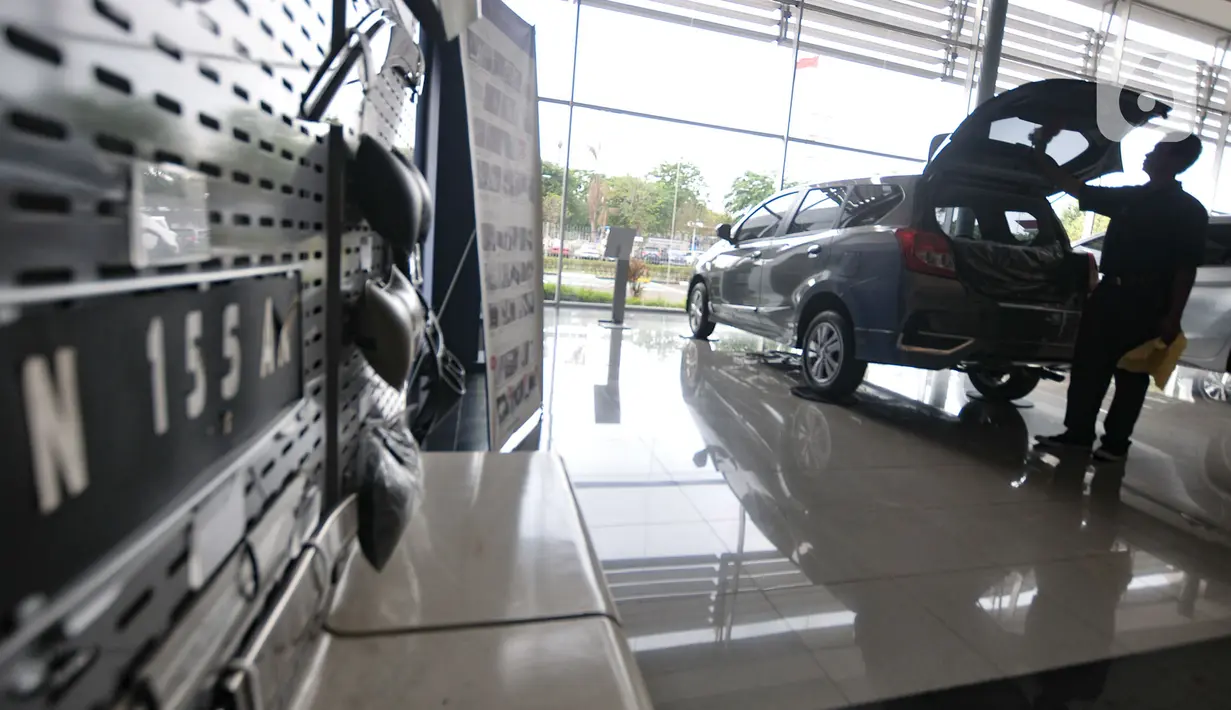 Pekerja membersihkan mobil Datsun Go+ Panca di Diler Nissan kawasan Pulogadung, Jakarta, Rabu (27/11/2019). PT Nissan Motor Indonesia berencana untuk menghentikan produksi Datsun di Indonesia pada 2020 mendatang. (merdeka.com/Iqbal Nugroho)