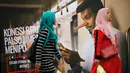 Penumpang kereta berjalan dengan latar belakang iklan larangan penyebaran hoax atau berita bohong di Stasiun Kereta Kuala Lumpur, Malaysia, Senin (2/4). Pengesahan UU Antihoax menyebabkan sejumlah pihak khawatir. (AP Photo/Vincent Thian)