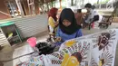 Perajin membuat batik tulis khas Betawi di rumah produksi Keluarga Batik Betawi, Setu Babakan, Jakarta Selatan, Minggu (10/3). Batik Betawi ini bermotif ondel-ondel, bunga manggar hingga Monumen Nasional (Monas). (merdeka.com/Arie Basuki)