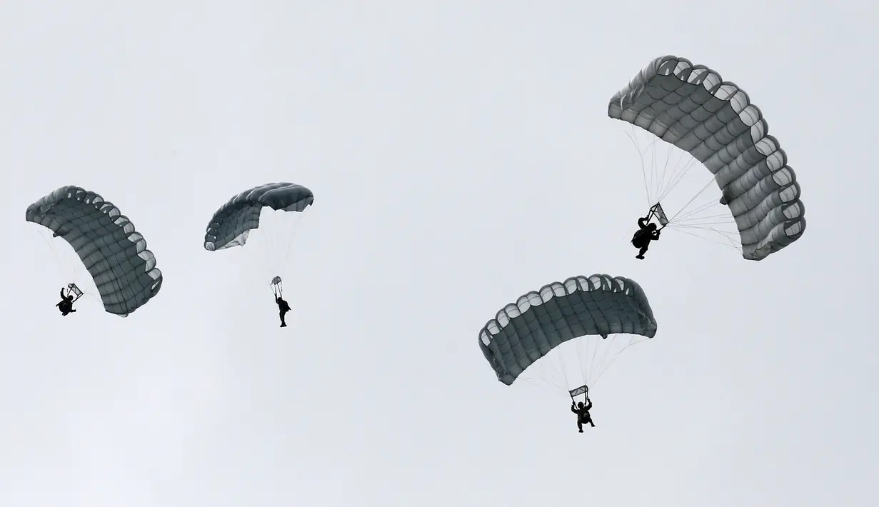 Sejumlah tentara Self-Defense Force melakukan manuver terjun payung dalam sesi latihan tahunan di dekat Gunung Fuji di lapangan pelatihan Higashifuji di Gotemba, Tokyo, (25/08). Latihan digelar untuk meningkatkan keamanan. (REUTERS / Kim Kyung-Hoon)