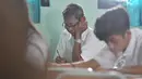 Seorang pria terlihat mengerjakan soal Ujian Nasional (UN) kesetaraan paket B di SMPN 80 Jakarta, Senin (4/5/2015). Sebanyak 378 peserta, termasuk peserta berusia lanjut mengikuti UN di hari pertama tersebut. (Liputan6.com/Johan Tallo)