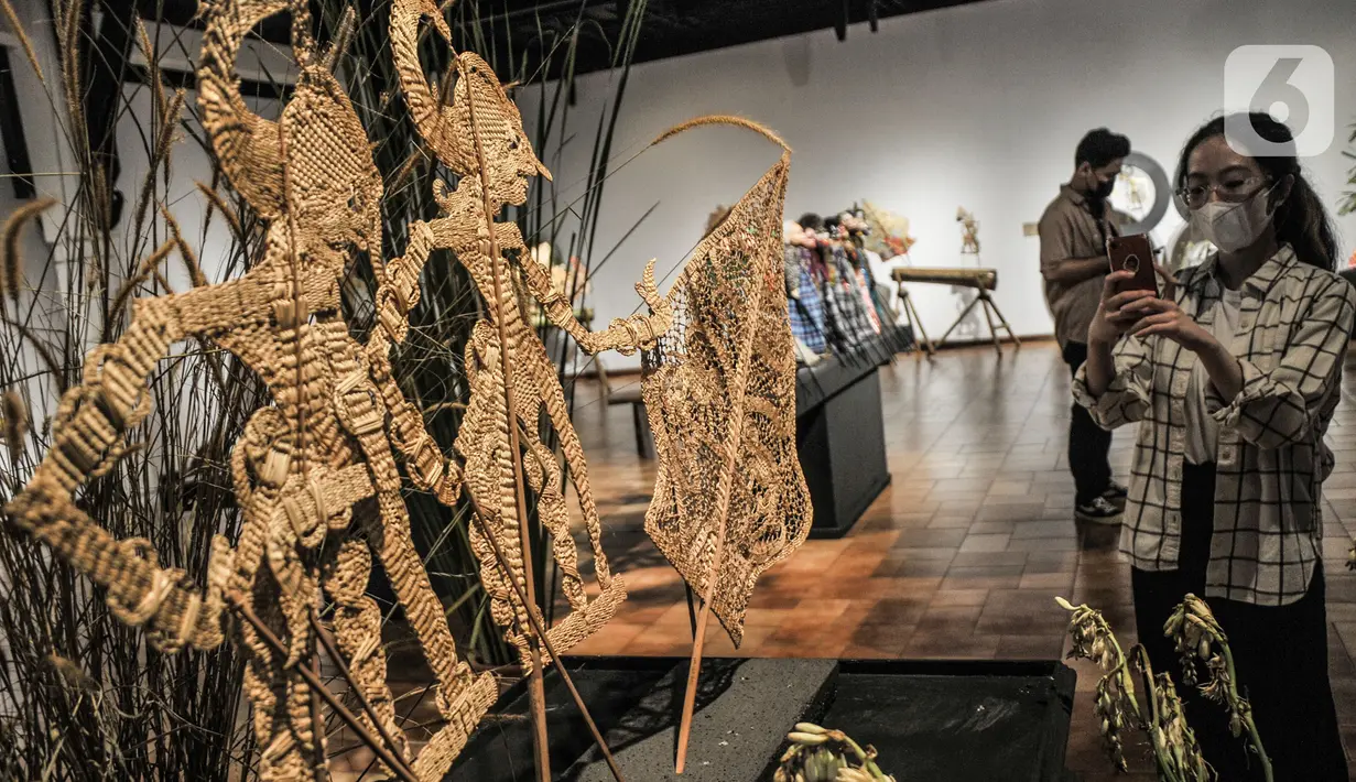 Pengunjung mengamati salah satu koleksi wayang yang ditampilkan dalam pameran 'Wayang Rupa Kita' di Bentara Budaya, Palmerah, Jakarta, Senin (22/11/2021). Pameran menghadirkan berbagai jenis wayang mulai dari wayang kulit, wayang golek, serta wayang suket (rumput). (merdeka.com/Iqbal S. Nugroho)