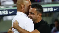 Pelatih Barcelona Xavi Hernandez memeluk manajer Manchester City, Pep Guardiola pada sebuah laga amal di Stadion Camp Nou, Kamis (25/8/2022) dinihari WIB. Pertandingan ini menjadi pertemuan perdana Pep Guardiola dan Xavi Hernandez yang pernah bekerja sama di Barcelona sebagai pelatih dan pemain selama rentang waktu 2008–2012. (AP Photo/Joan Monfort)